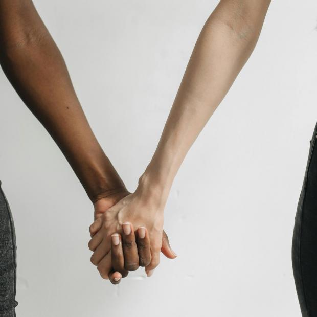 Two people holding hands